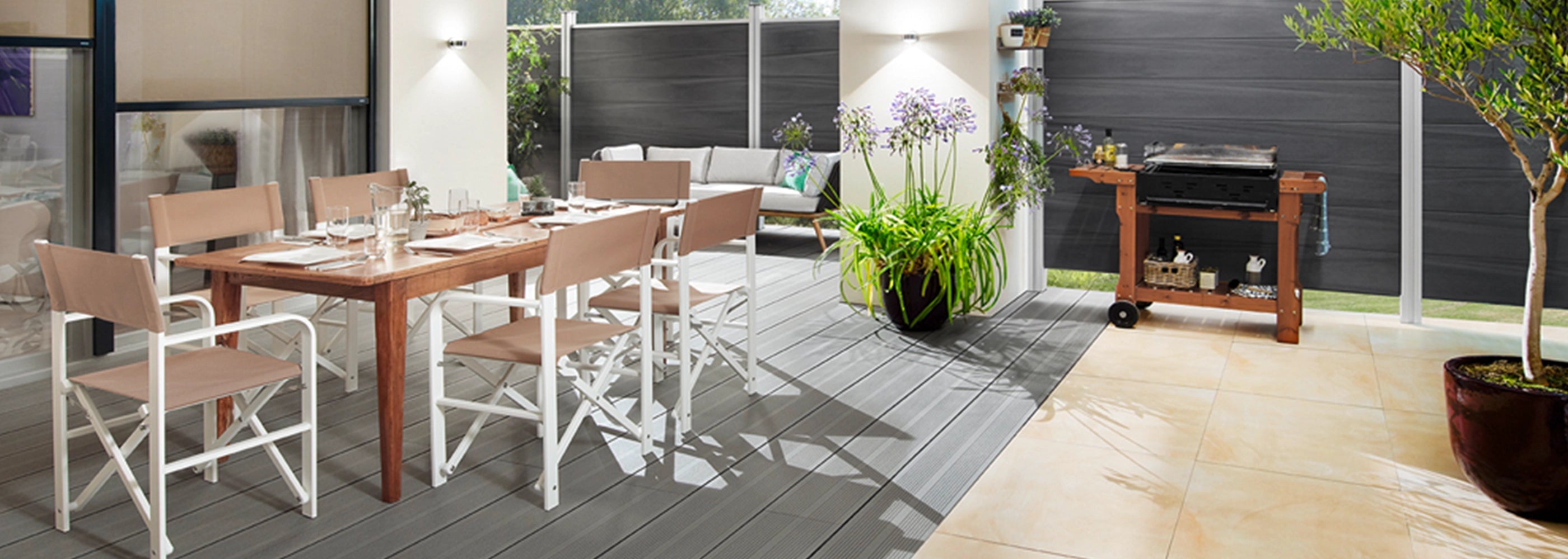 Weiße Regiestühle Sofia aus Aluminium mit grau-beigem Stoff auf einer modernen Terrasse mit Holztisch und Grillbereich.